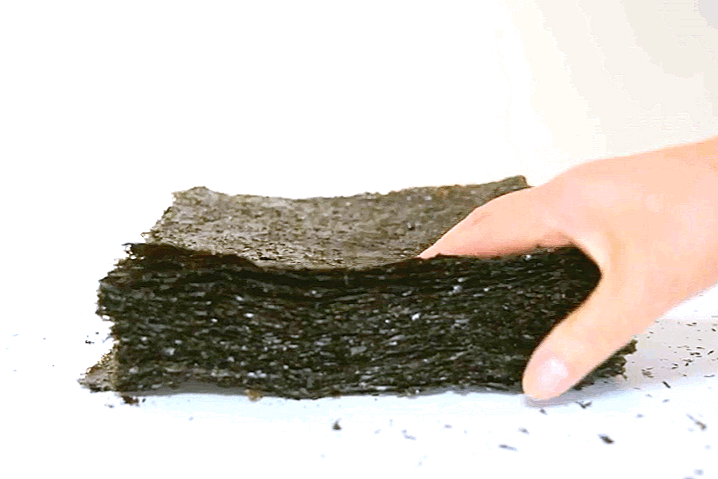 a hand touching a piece of black material